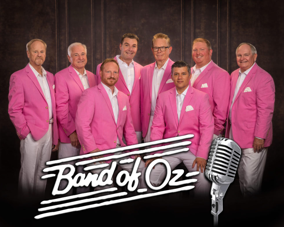 eight male band members in pink dress jackets band of oz